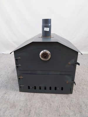a small metal stove with a clock on top of it