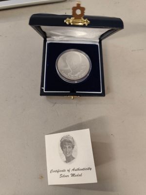 a silver coin with a picture of a woman in it