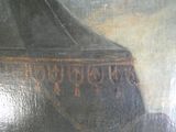 un tableau représentant un vase noir sur lequel figurent des inscriptions