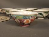 a bowl with a design on it sitting on a table next to other bowls