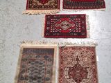 four rugs are laid out on the floor in a room