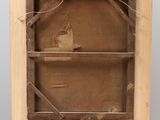 an old wooden easel with a piece of wood on top of it