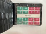 a black wallet with a bunch of stamps in it