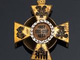 an image of a gold cross with a crown on top of it