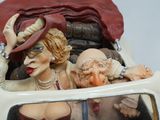 a figurine of a woman and a man in a car