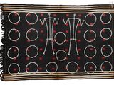 a close up of a black and red rug with circles on it