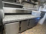 a kitchen with stainless steel cabinets and a counter top