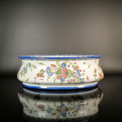 a blue and white bowl sitting on a black table