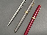 three different types of pens are lined up on a table