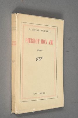 an old book sitting on top of a table next to a wall