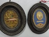 two framed pictures hanging on the wall of a room