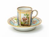 a cup and saucer with a picture of a couple on it