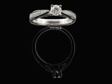 a close up of a diamond ring on a black surface