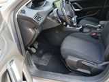 the interior of a car with the door open showing the driver ' s seat