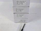 three boxes of toothbrushes sitting on top of each other on a table