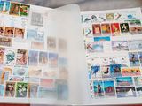 an open book with stamps on it sitting on a table