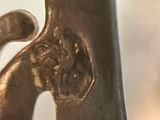 a close up of a metal sculpture of a cat