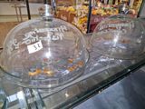 a glass display case filled with cakes and pastries