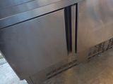 two stainless steel refrigerators that are sitting in a room