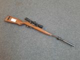 a rifle that is laying on the ground with a gun in it