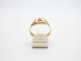 a close up of a gold ring on a white surface