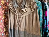 a lot of clothes hanging on a rack in a room