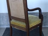 a wooden chair with a yellow cushion on it