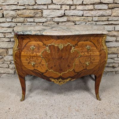 an antique chest of drawers with a marble top on a stand