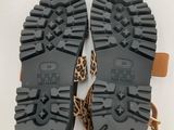 a pair of leopard print sandals on a white surface
