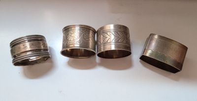 three silver napkin rings are sitting on top of a white table