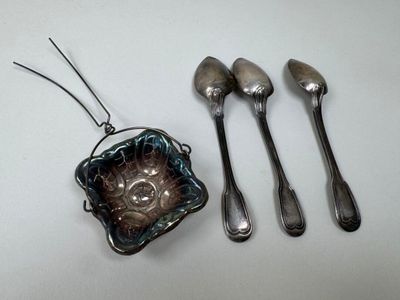 three spoons, a bowl, and a spoon rest on a table