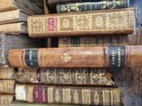 many old books stacked on top of each other
