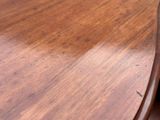 a close up of a wooden table with a clock on it