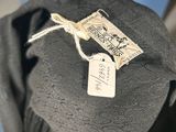 the back of a black hat with a tag on it