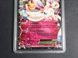 an image of a pokemon card with a pink background