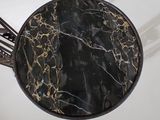 a table with a marble top on a white table