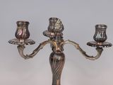 a silver candelab with two candles on it