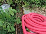 a red hose that is sitting on top of a box