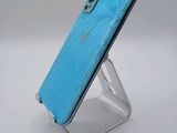 a close up of a phone with a broken screen on a stand