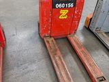 two forklifts sitting next to each other in a warehouse
