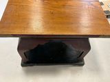 an old wooden table with a wooden top and a metal base