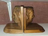 a wooden bookend with a statue of a man ' s head on it