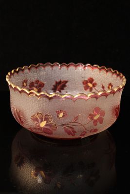 a close up of a bowl on a table with a black background