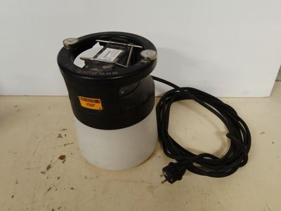 a close up of a black and white trash can with a power cord