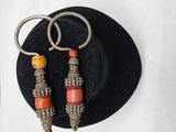 deux paires de boucles d'oreilles qui se trouvent sur un chapeau noir