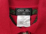 a close up of a red sweater with a label on it