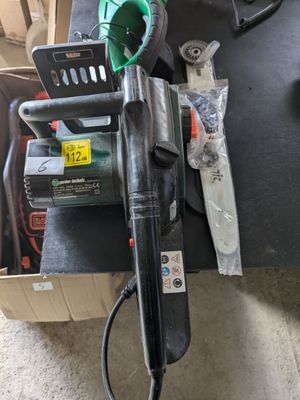 une photo montrant une perceuse électrique filaire et d'autres outils posés sur une table