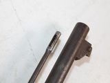 a metal pipe and a metal tube on a white surface