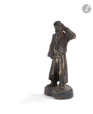 a bronze statue of a man with a hat on