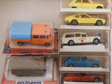 six toy cars in a display case on a table